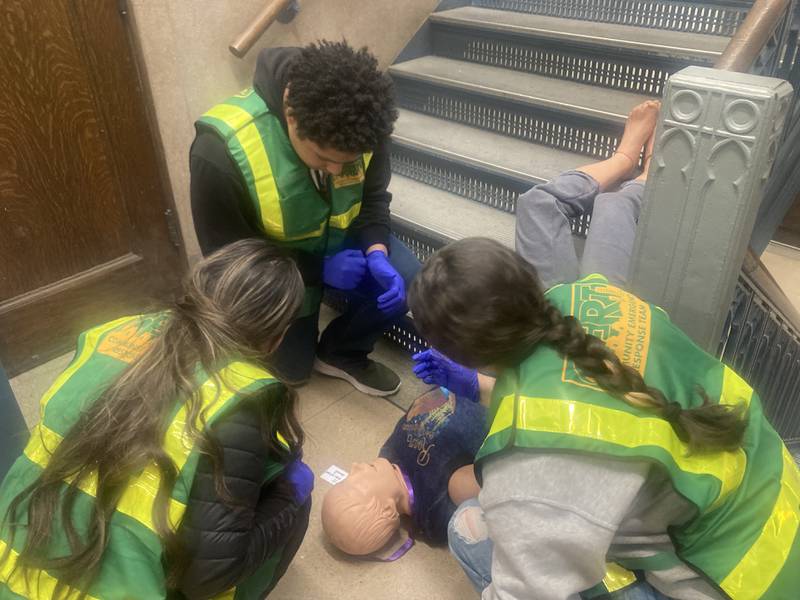 Joliet Central CERT students examine a dummy in a simulation of a student falling down the stairs and breaking multiple bones. 
Thursday, Dec. 11, 2025.