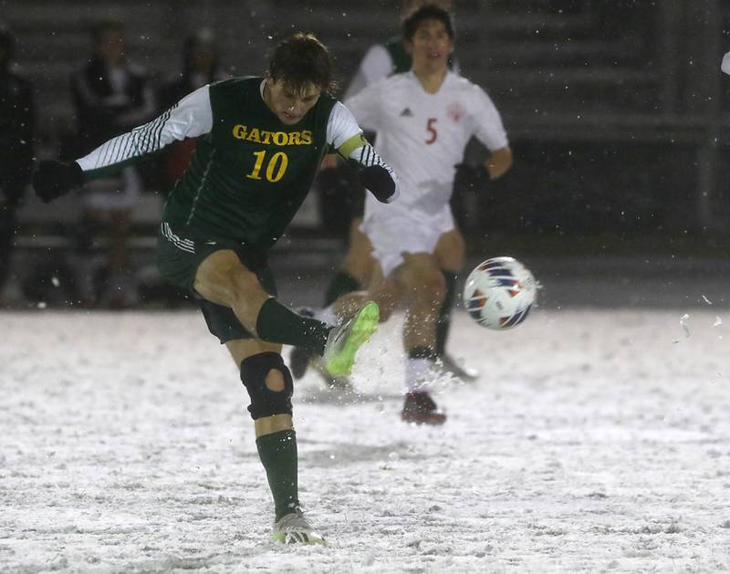 Crystal Lake South's Nolan Getzinger takes a shot at goal in front of Timothy Christian's Cooper Rainone during the IHSA Class 2A Grayslake Central Supersectional soccer match on Tuesday, Oct. 31, 2023, at Grayslake Central High School.