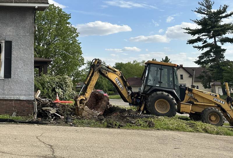 A backhoe begins to demolish a home located in the 800 block of Bucklin Street on Thursday, May 7, 2026 in La Salle. The home was destroyed by a fire on Jan. 23. Firefighters worked together to battle the blaze in subzero temperatures.