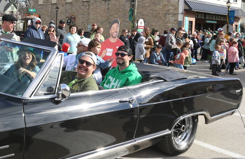 Jake from State Farm rides in the back of a classic Buick Wildcat car during the St. Patrick's Day parade on Saturday, March 16, 2024 downtown Utica.