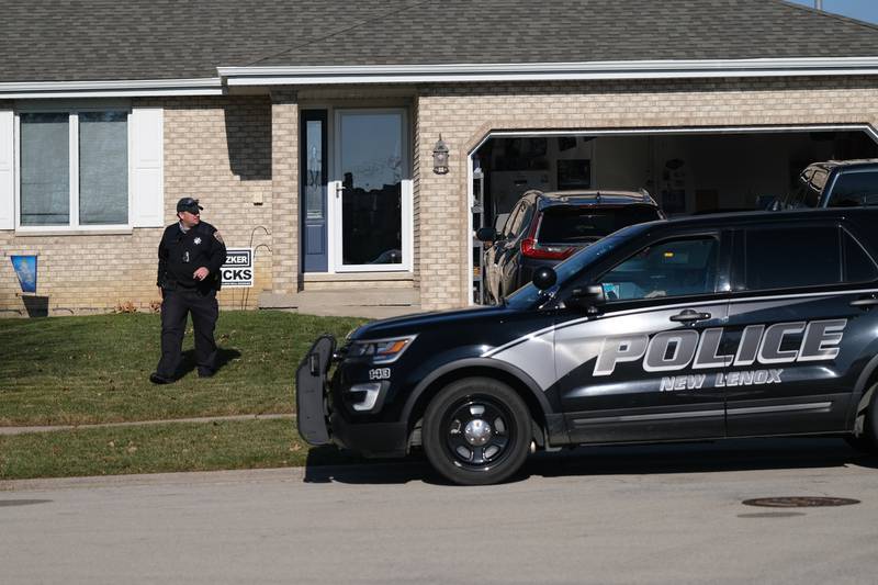 A New Lenox police officer leaves the home at the 1900 block of Grand Prairie Driver. A 21-year old man shot his father at the home on Grand Prairie Drive in New Lenox early Monday morning. Monday, Dec. 20, 2021 in New Lenox.