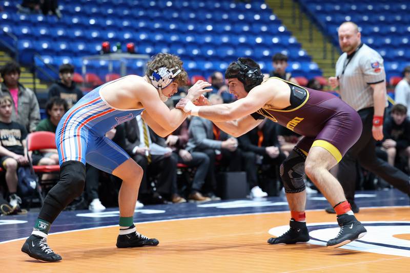 Marmion Academy's Grayson Garcia, left, wrestles Montini's Santino Tenuta in the 165-pound match during Marmion Academy's victory over Montini in the IHSA Class 3A Dual Team State championship on Saturday, Feb. 28, 2026.