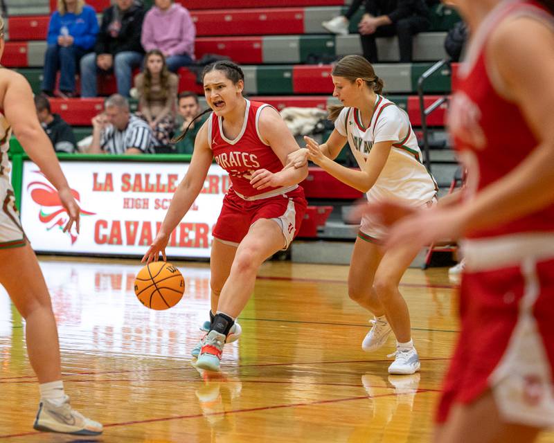 Mary Stisser (23) of Ottawa dribbles ball down lane as April Pescetto (1) of LaSalle-Peru trails on Wednesday, December 17, 2025 at Sellet Gymnasium in LaSalle.
