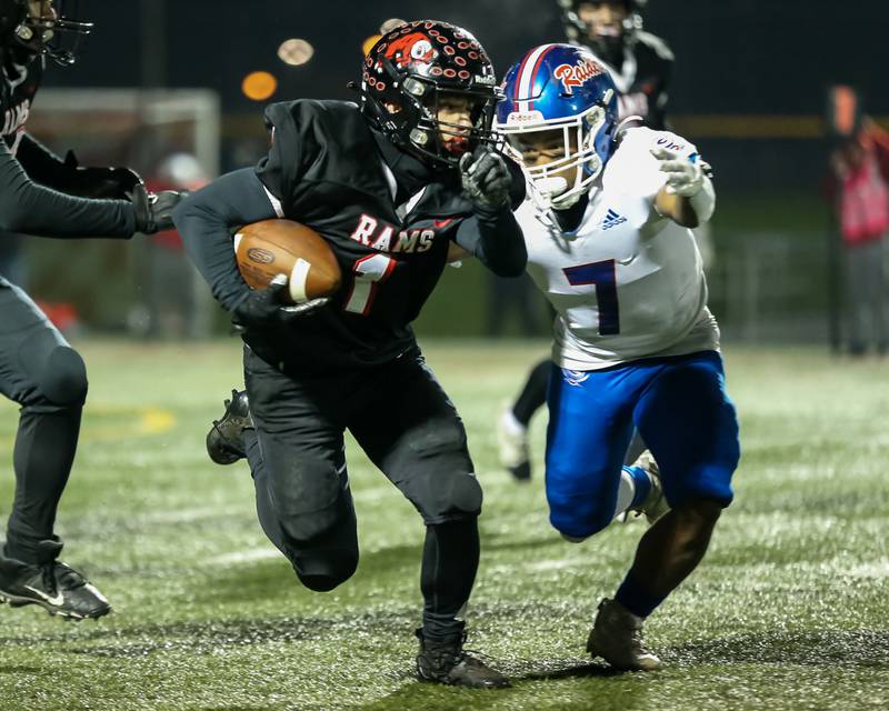 Glenbard East's Matthew Larson (1) runs away from Glenbard South's Justin Jones (7) during football game between Glenbard South at Glenbard East.   Oct 13, 2023.