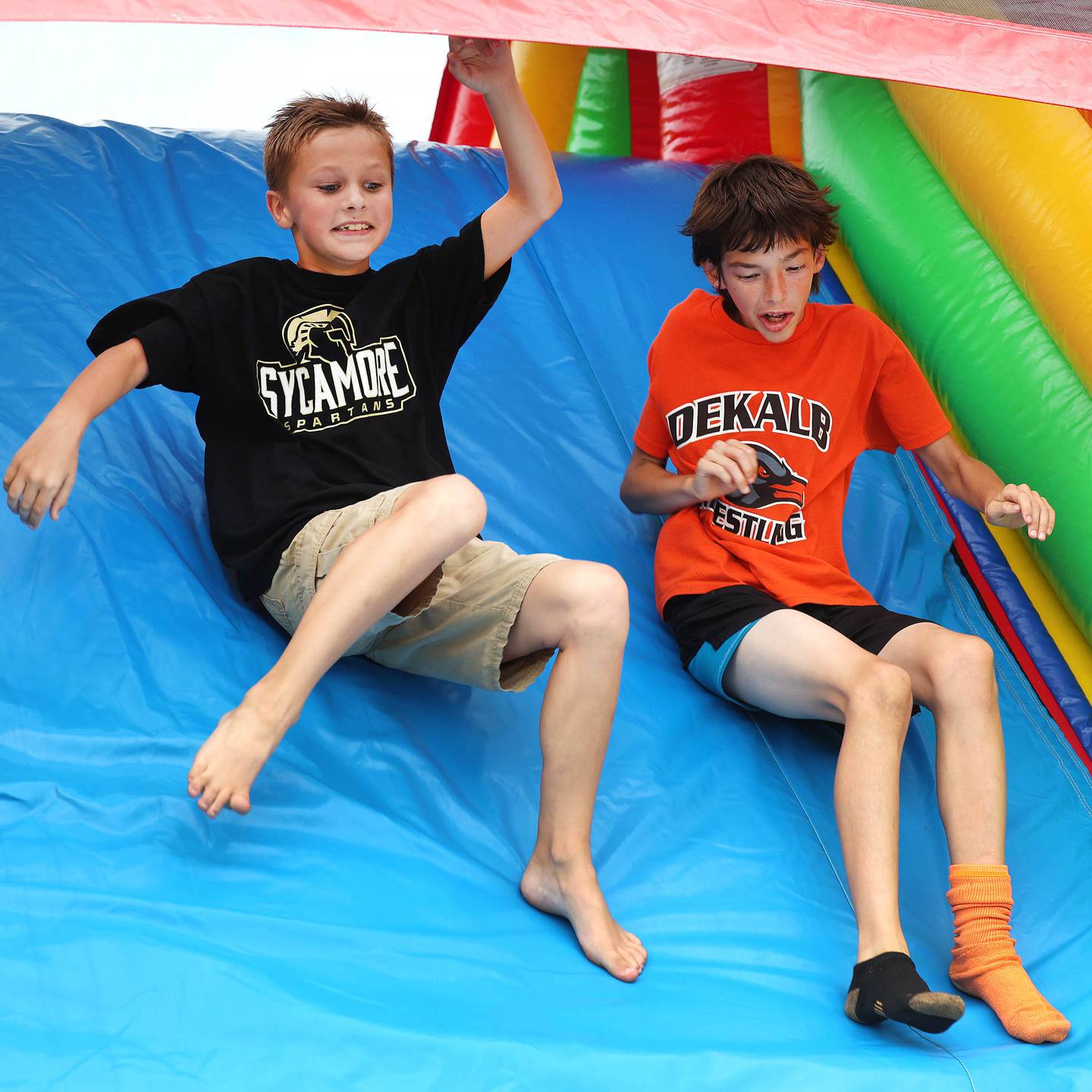 Jacob Evans, (left) 9, from Sycamore, races Nathan Krupa, 11, from DeKalb, through the obstacle course in the tailgate Friday, Aug. 30, 2024, before DeKalb, Sycamore football game in the the FNBO Challenge at Huskie Stadium at Northern Illinois University.
