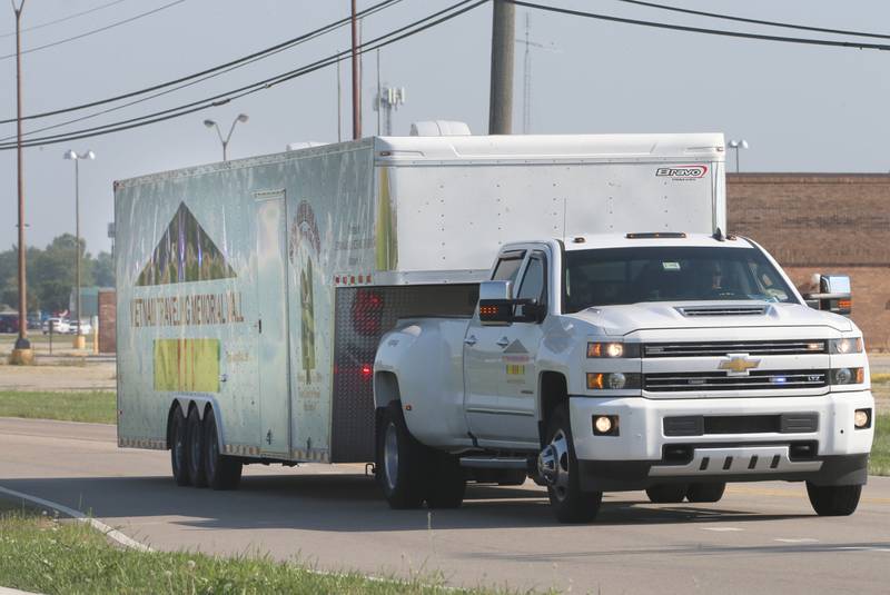 The Vietnam Traveling Memorial Wall travels down Peoria Street during a procession on Thursday, Aug. 24, 2023 on in Peru.