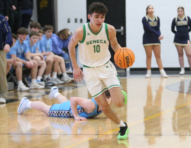 Seneca's Brayden Simek sprints down the floor after grabbing a loose ball from Marquette's Alec Novotney during the Tri-County Conference championship on Friday, Jan. 31, 2025 at Putnam County High School.