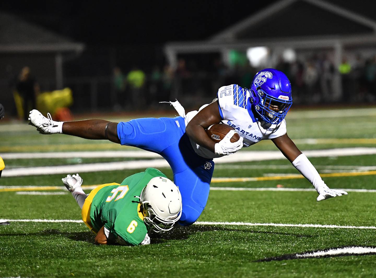 Providence Catholic's defenders wraps up St. Francis Tivias Caldwell (42) during the non-conference game on Friday, SEP. 26, 2025, at New Lenox.