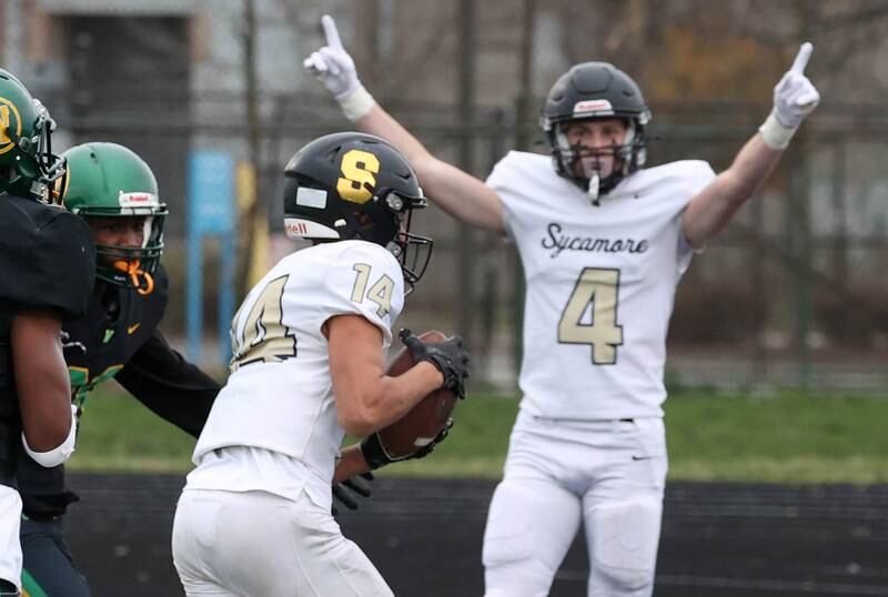 Sycamore's Josiah Mitchell scores a touchdown late in the first half as teammate Aidan Wyzard celebrates Saturday, Nov. 9, 2024 during their Class 5A second-round playoff game against Westinghouse at Knute Rockne Stadium in Chicago.