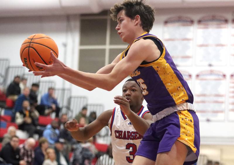 Dundee-Crown’s Kadin Malone, back, and Wauconda’s Sebastian Klein look for a rebound in varsity basketball Friday, Dec. 20, 2024 at Dundee-Crown High School in Carpentersville.
