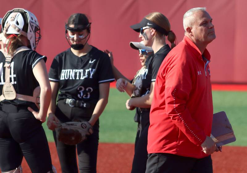 Huntley’s Head Coach Mark Petryniec leaves the pitching circle after a meeting in IHSA Class 4A Sectional Title Game softball action at the Fields of Dreams on the campus of Barrington High School in Barrington on Friday, June 6, 2025.