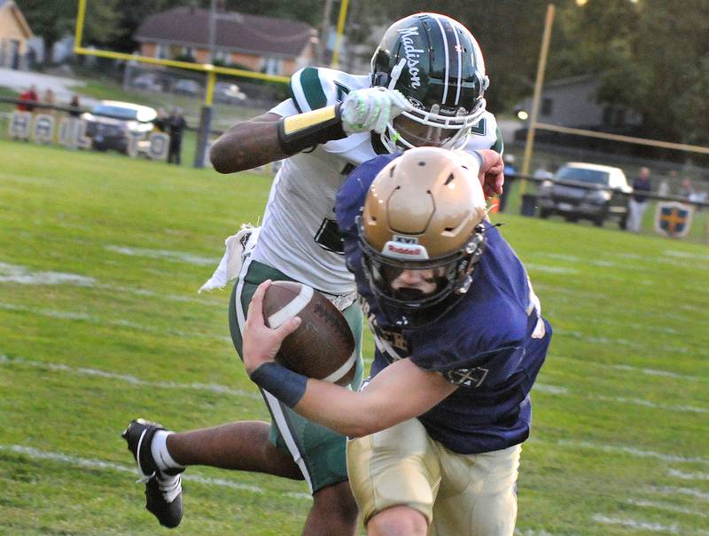 Marquette’s Jaxnsen Higgins breaks away from Madison’s Shane Bennet for a touchdown n the 1st quarter Friday at Marquette.