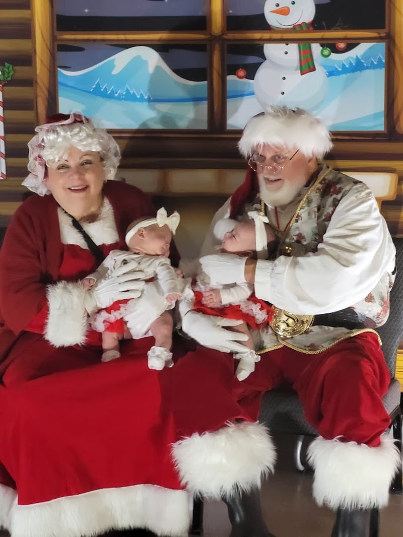 Santa and Mrs. Claus with two twin infants, the last two children they visited with for An Evening with Santa.