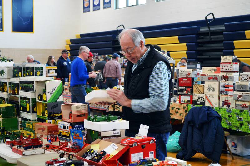 Jim Klenke, of Janesville, Wisconsin, prepares to set up a John Deere Model 494-A four-row planter for display at his table at the Polo Lions Club’s 38th Farm Toy Show. The event was held at Polo Community High School on March 4.
