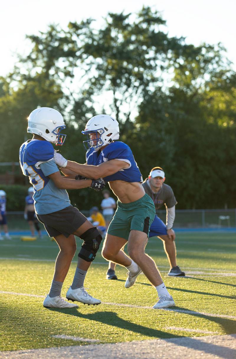 Karsten Libby,right, practices blocking during practice at Wheaton North on Thursday, Aug. 11, 2022.