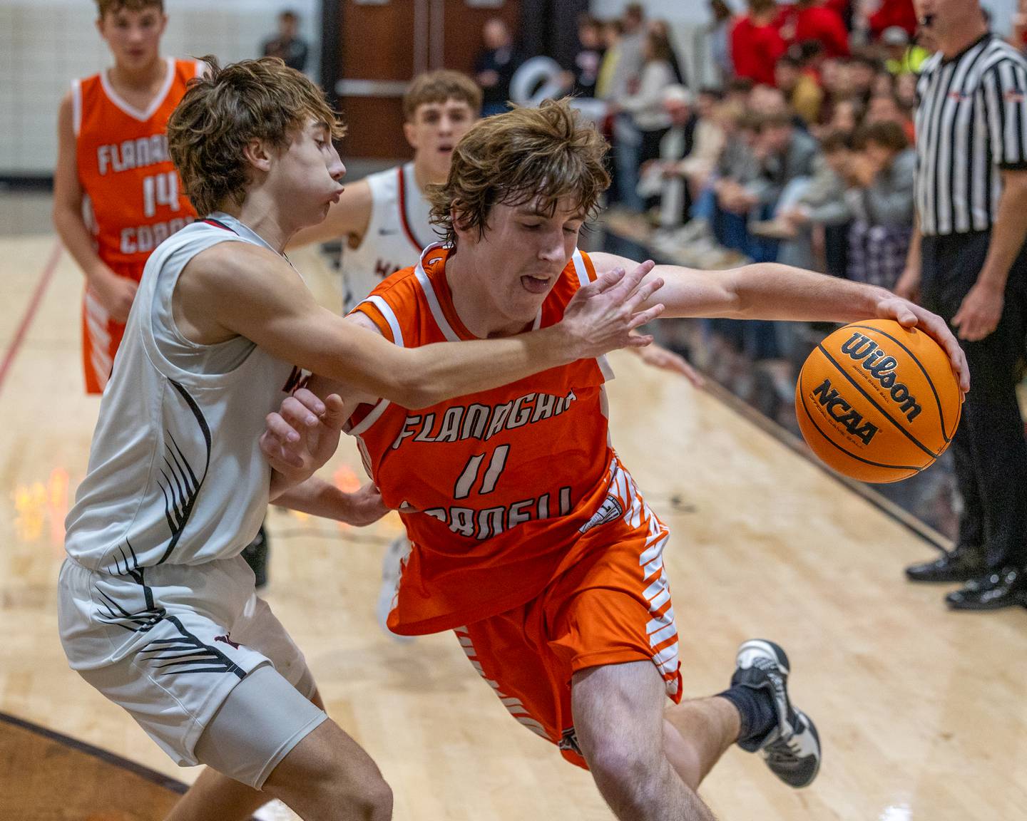 Logan Ruddy (11) of Flanagan-Cornell drives the ball as Woodland's Grant Wissen (3) defends Wednesday, Nov. 26, 2025, in rural Streator.