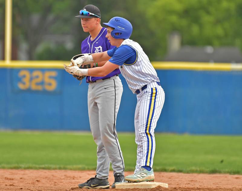 Lyons Township’s Lon Roberts (right) signals to the dugout from second base after hitting a double as Downers Grove North second baseman Rhys Dominow stands by during a game on May 18, 2026 at Lyons Township High School in LaGrange.