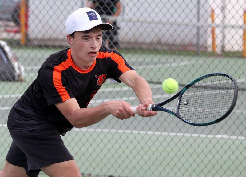 DeKalb number one doubles player Ryan Lottes reaches for a backhand Thursday, April 24, 2025, during their match at Sycamore High School.