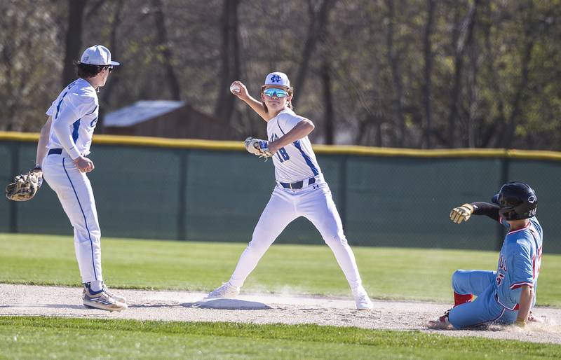 Newman’s Garet Wolfe makes the throw to first to complete a double play against Hall Monday, April 15, 2024 at Newman High School.