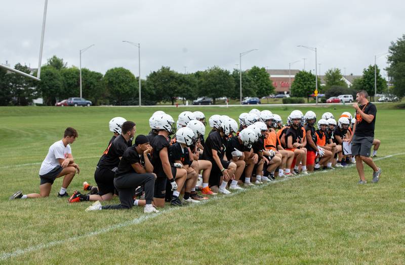 St. Charles East Coach Nolan Possley talks to the team at the end of practice at St. Charles East on Monday, Aug. 8, 2022.