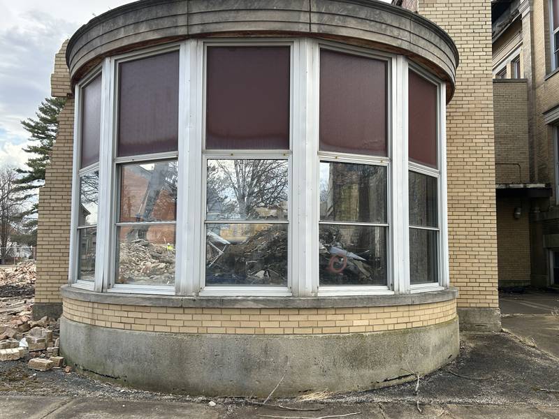 An excavator from Fischer Excavating, of Freeport, can be seen through the round window portion of the Congress School, 208 N. Congress Ave., as demolition continued on Friday, March 28, 2025 in Polo.. Demolition of the older, larger portion of the building has been tentatively set for Monday.