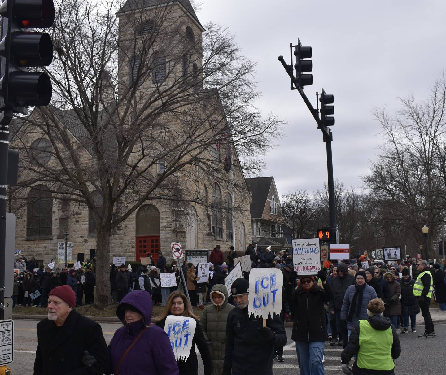Demonstrators march along La Grange Road in La Grange Sunday as part of a protest against ICE and the Trump administration