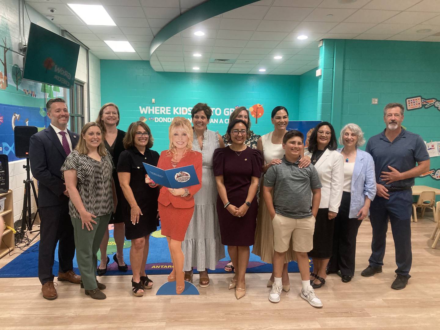 State and county officials stand with corporate donors and a cut out of Dolly Parton at the launch event for Will County's Imagination Library program. 
Monday, July 28, 2025.