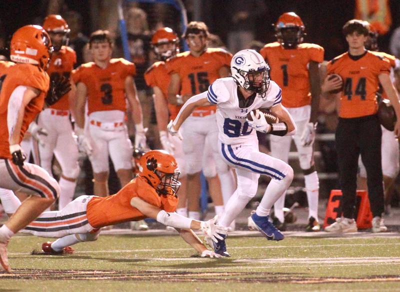 Geneva’s Bennett Konkey (right) escapes the grasp of Wheaton Warrenville South’s Colin Cahill during a September game in Wheaton.