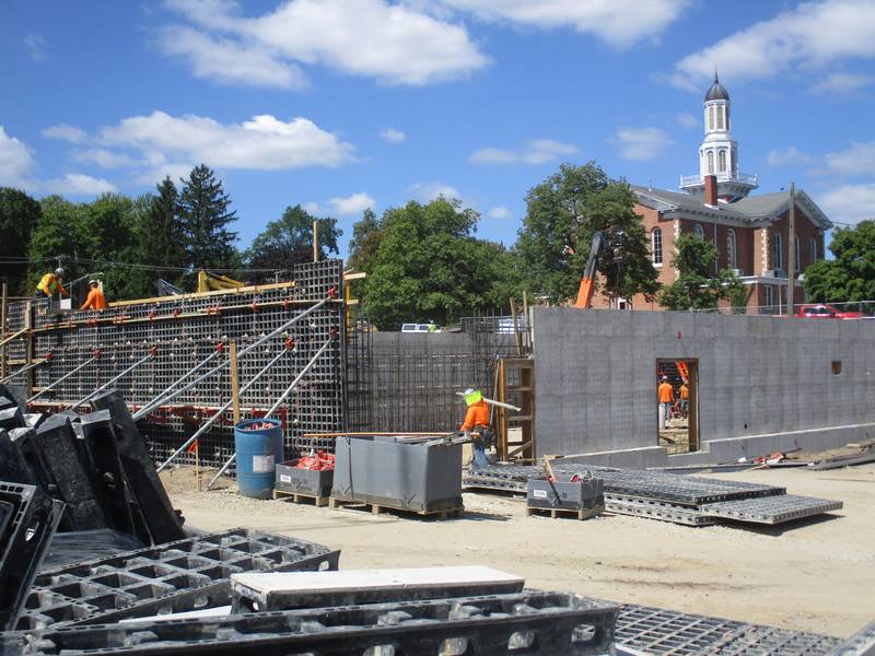 Construction workers build the foundation for the new Kendall County Clerk and Recorder office building in downtown Yorkville on Aug. 30, 2023. The Historic Kendall County Courthouse looms in the background.