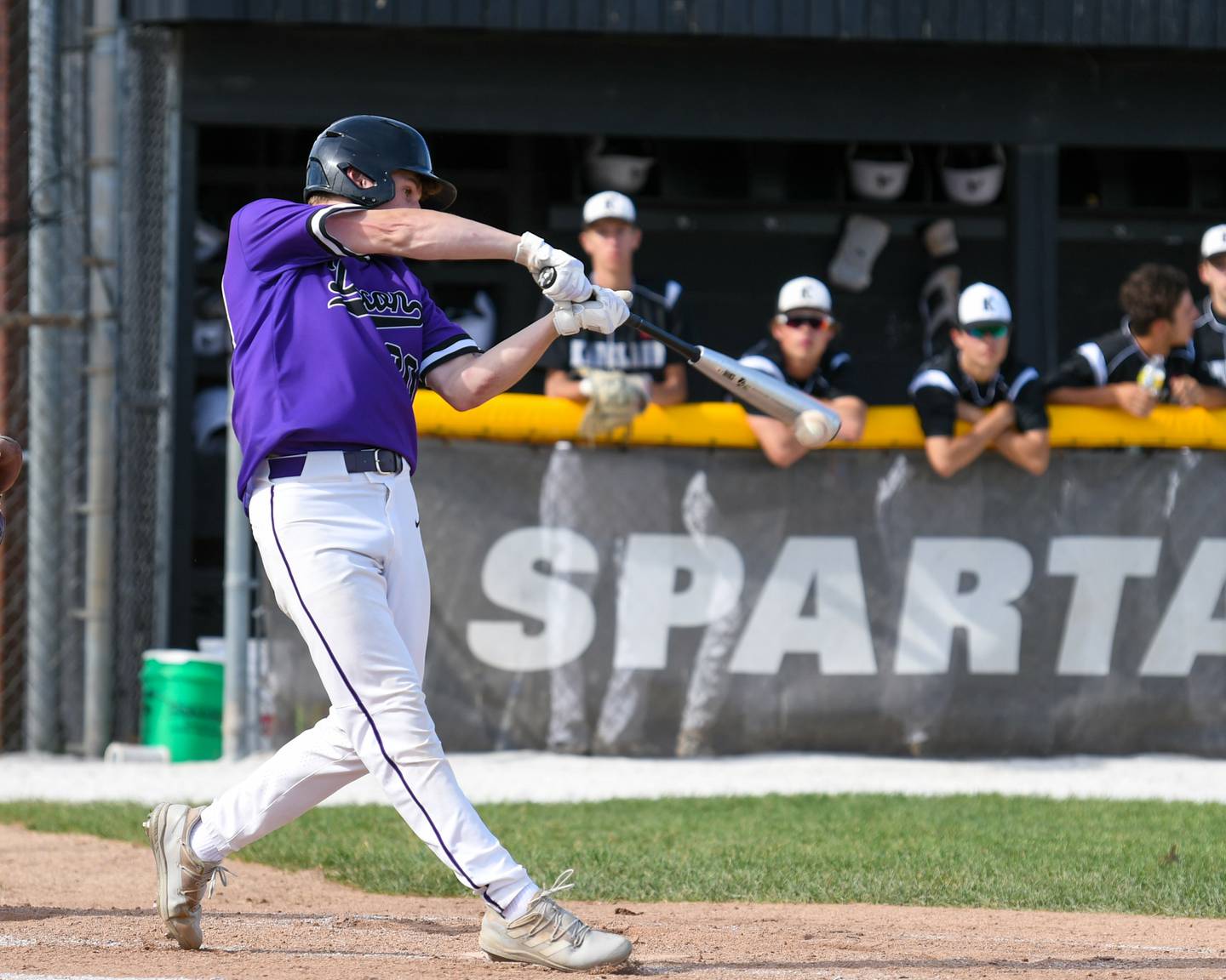 Dixon's Max Clark makes contact for a base hit on Wednesday, June 1, 2022 while taking on Kaneland High School during a sectional playoff game held in Sycamore.