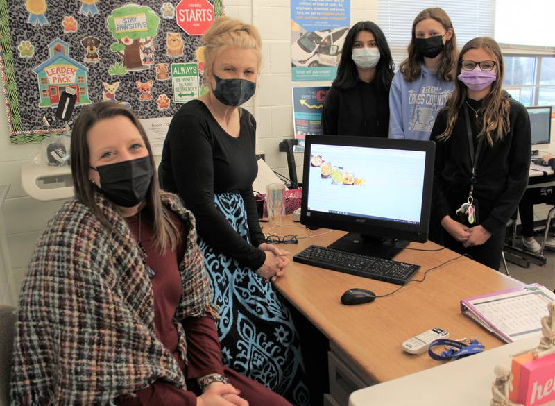 Troy seventh grade students in Debra Benson’s consumer technology class recently designed and coded their own one-page website using HTML and CSS coding programs. Pictured (back from left) are students Vanessa Estrada, Lila Abbott and Hunter Biederman with the website they coded. Pictured (front, left) are Troy 30-C educational technology coordinator Sarah Wells and consumer technology teacher Debra Benson.