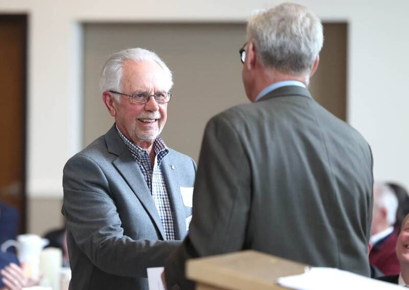 Ed Kuhn, (left) smiles as comes up to accept the Clifford Danielson Outstanding Citizen Award during the 107th Annual Sycamore Chamber of Commerce Meeting Thursday, March 7, 2023, in Memorial Hall at St. Mary's Catholic Church in Sycamore.