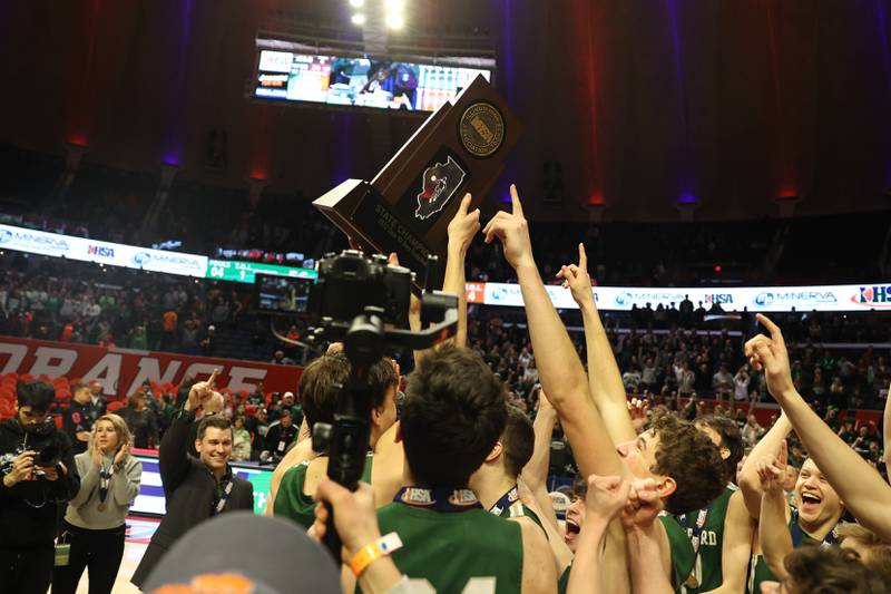 Glenbard West hoist the championship trophy after their 56-34 win over Whitney Young in the Class 4A championship game at State Farm Center in Champaign. Saturday, Mar. 12, 2022, in Champaign.