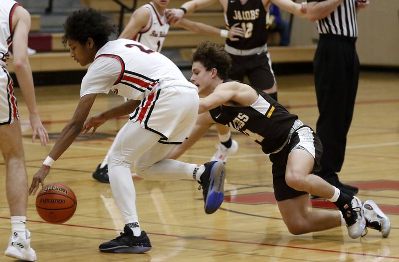 Huntley's Omare Segarra chases down a loose ball in front of Jacobs' Brett Schlicker during a Fox Valley Conference boys basketball game Tuesday, Jan. 24, 2023, at Huntley High School.