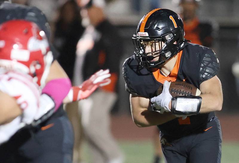 DeKalb's Talen Tate carries the ball during their game against Naperville Central Friday Oct. 7, 2022, at DeKalb High School.