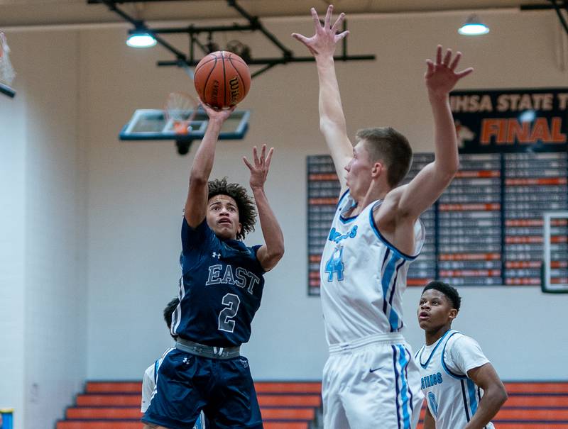 Oswego East's Bryce Shoto (2) shoots the ball in the post over Downers Grove South's Justin Sveiteris (44) during the hoops for healing basketball tournament at Naperville North High School on Monday, Nov 21, 2022.