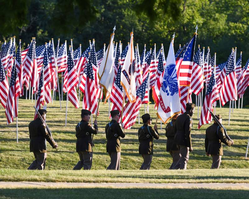 Chicago Recruiting Battalion, U.S. Army, passes by the Field of Honor that is displaying 500 American Flags to honor veterans, active military, first responders as well as frontline workers on Sunday Sep. 3, 2023, at Denning Park in La Grange.