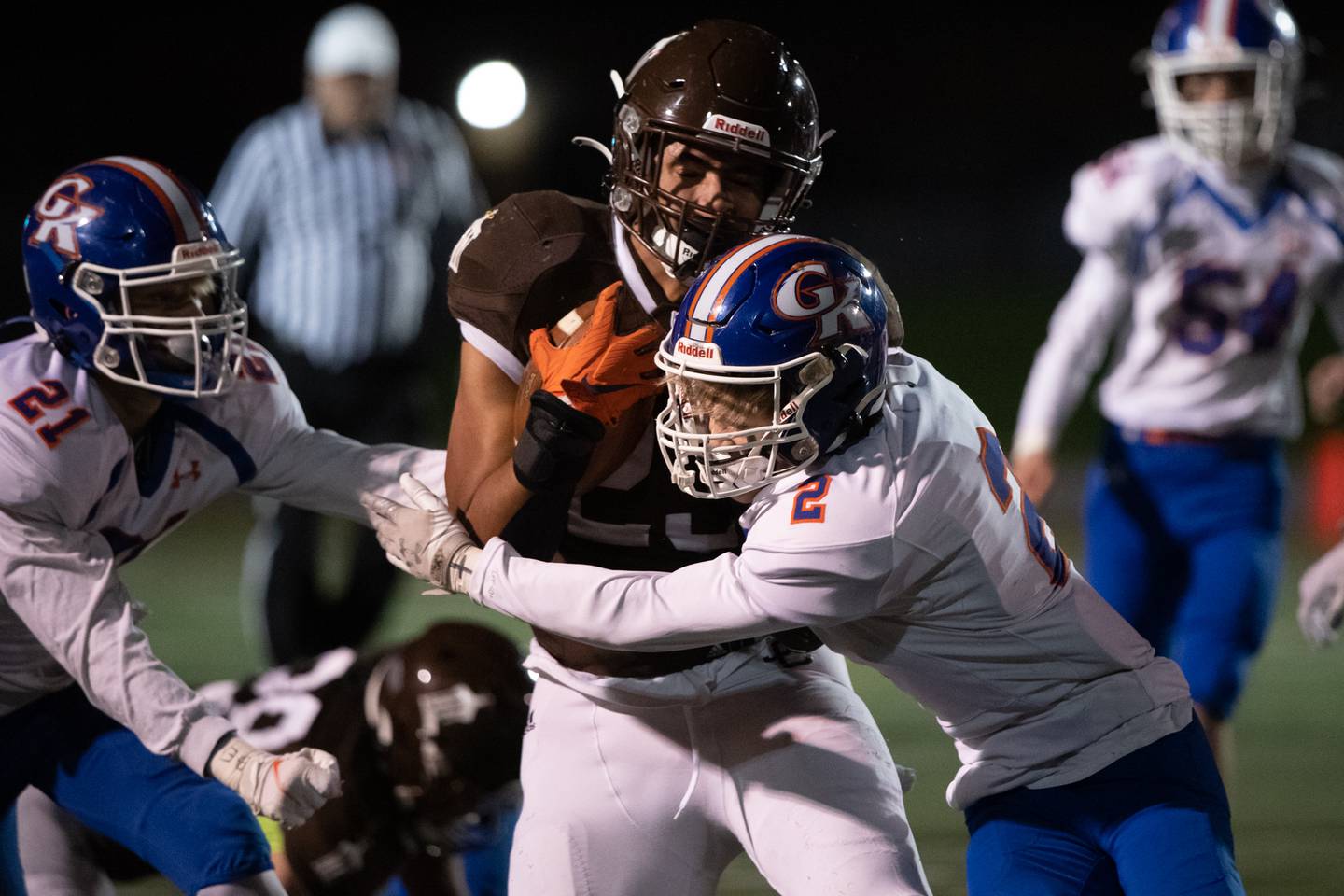 Genoa-Kingston's Brody Engel, (right) and Jake Oates tackle Joliet Catholic's Jordan Anderson during their IHSA Class Class 4A football playoff quarterfinal game at Joliet Memorial Stadium on Saturday,Nov. 13, 2021.