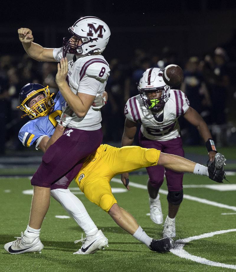 Sterling’s Wyatt Cassens forces a fumble of Moline’s Kasen Ponder Friday, Sept. 12, 2025.
