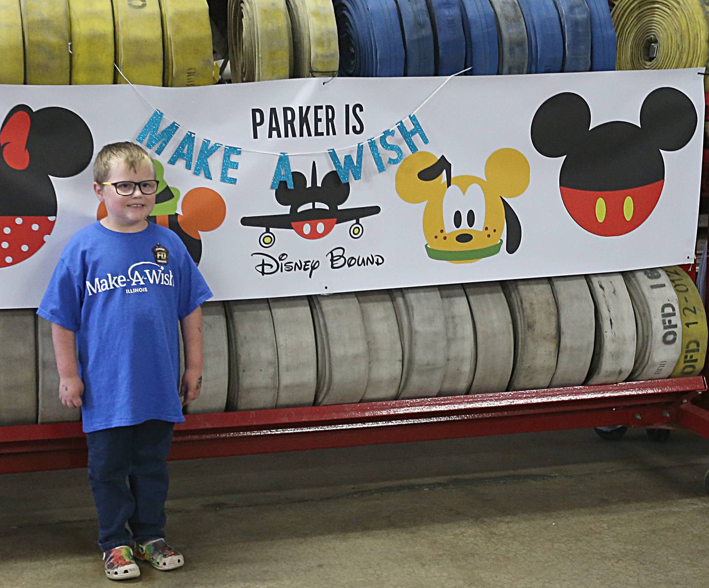 Parker Vangelder 6, of Seneca poses for a photo next to his Make-A-Wish banner at the Ottawa Fire Department on Monday, Oct. 10, 2022. Vangelder and his family are going to Walt Disney World later this month.