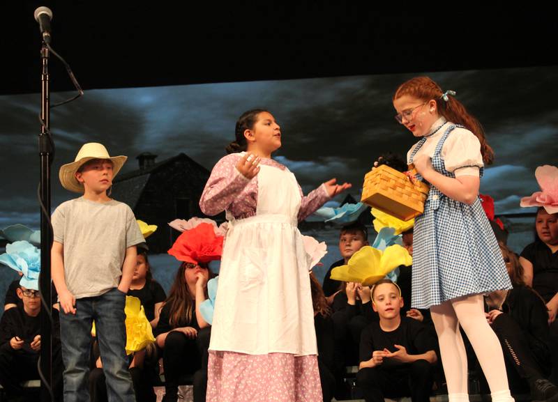 Uncle Henry (Caleb Miller) and Auntie Emm (Sophia Gonzalez) talk with a distraught Dorothy (Karsyn Stewart) on Friday, March 22, 2024, during the Streator Elementary Schools production of "The Wizard of Oz – Youth Edition" at Streator High School.