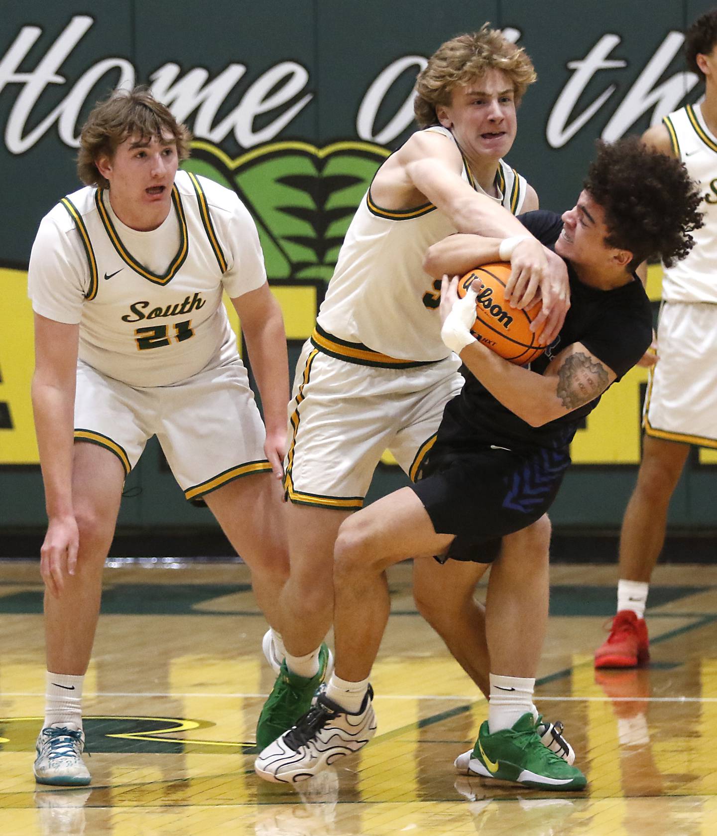 Crystal Lake South's Carson Trivellini creates a jump ball as he ties up Burlington Central's Caden West as his teammate, Ryan Morgan ,looks on during a Fox Valley Conference basketball game on Tuesday, Jan. 28, 2025, at Crystal Lake South High School.