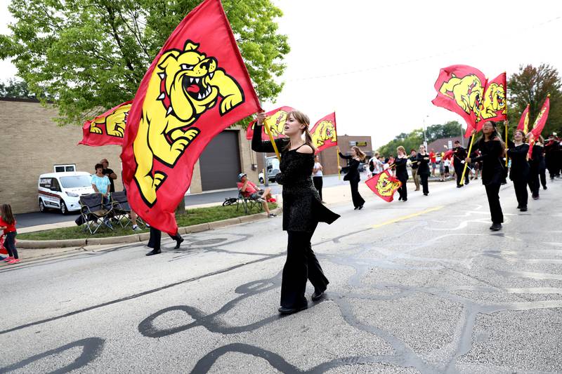 Batavia High School flag corps members march down Wilson Street during the school’s annual homecoming parade on Wednesday, Sept. 20, 2023.