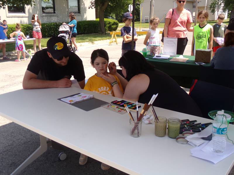 Norah Tomano gets her face painted by Tegan Finnegan, of the Reddick Library, on Saturday, June 3, 2023, during the Summer Reading Kick-Off Party.