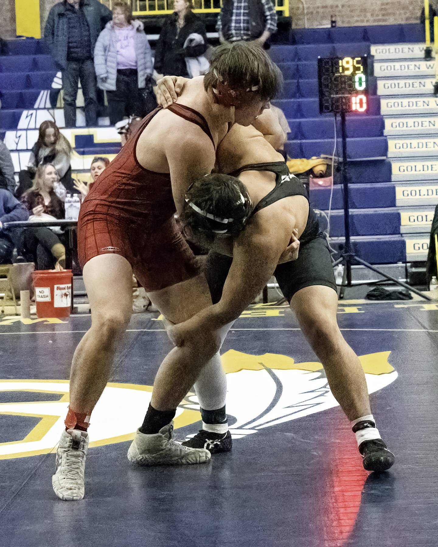 Erie-Prophetstown's Luke Otten (left) and Dixon's Ethan Mick grapple during their 195-pound title bout at the 44th annual Carson DeJarnatt Tournament on Saturday, Dec. 3, 2022 at Musgrove Fieldhouse in Sterling.