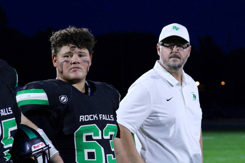 Rock Falls senior Triston Shaw and coach Kevin Parker represent the team during the coin flip on Friday during the homecoming game against North Boone on Friday, Oct. 8, 2021. This was Parker's return to the sidelines after the Sept. 24 death of his son, senior lineman Brock Parker.