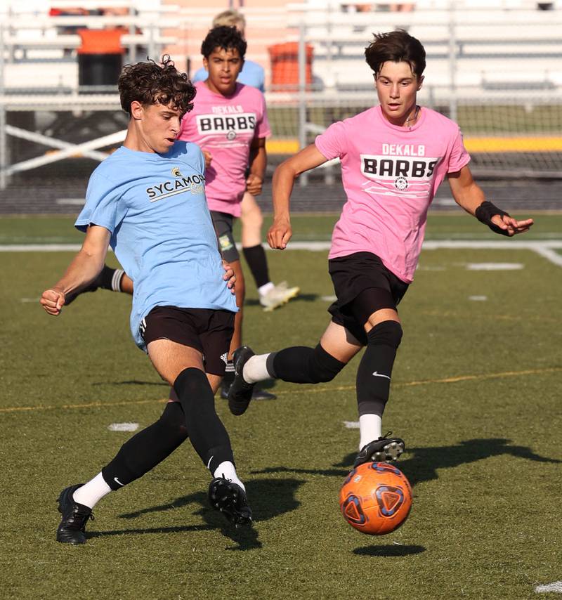 Sycamore’s Noah Daykin pushes the ball ahead of a DeKalb player Monday, July 14, 2025, during a summer boys soccer friendly at DeKalb High School.