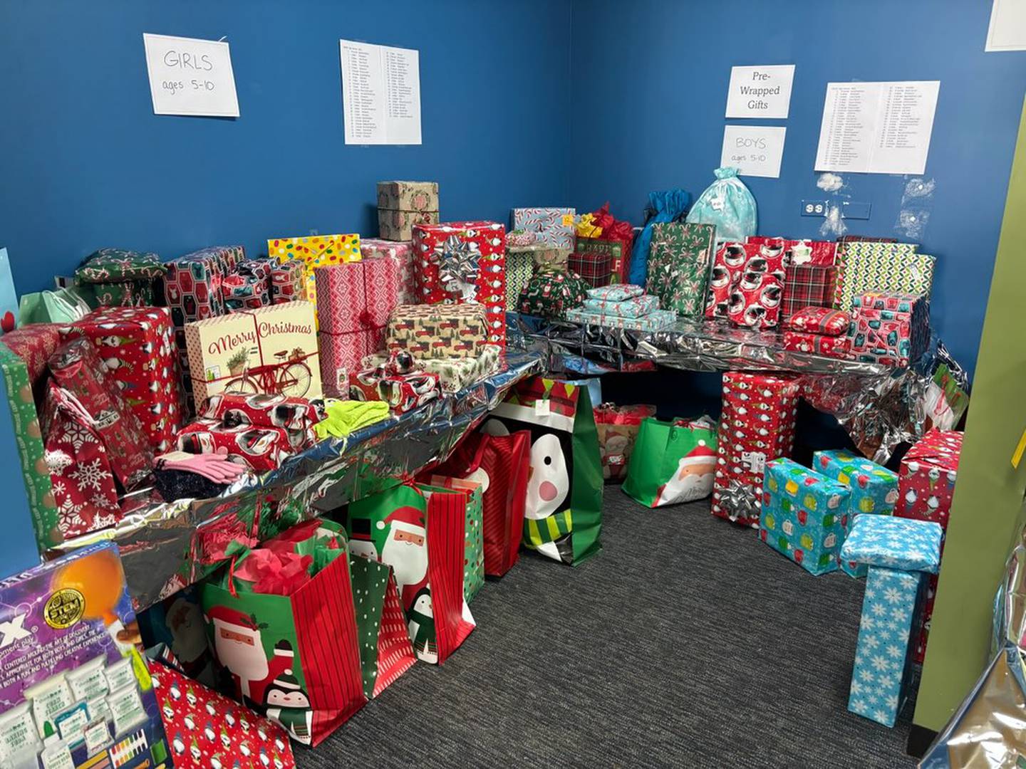 After unwrapped gifts are chosen, the CASA Kane County volunteers can have the presents wrapped or wrap themselves, all at a donated storefront provided by Corcoran Commercial Real Estate. Some 1,200 children will receive gifts this year – 613 CASA foster children as well as the foster siblings in the home.