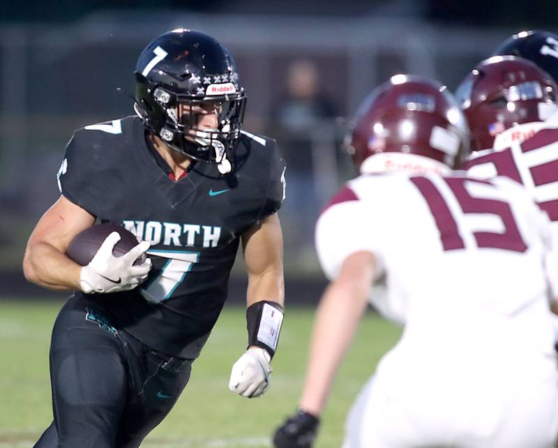 Woodstock North’s Parker Halihan runs the ball in varsity football at Rod Poppe Field on the campus of Marengo High School in Marengo on Friday, Sept. 12, 2025.