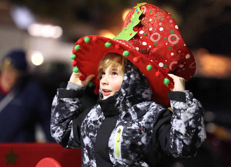 Frankie Gates, 8, from Genoa, adjusts his festive hat as he waits for the parade Friday, Dec. 2, 2022, during Celebrate the Season hosted by the Genoa Area Chamber of Commerce.